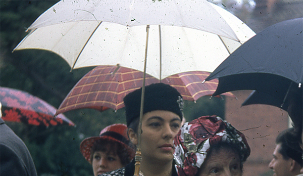 Sample scan - colour restored scan of a  woman at a wedding under a umbrella